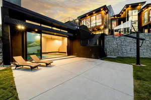 Indoor/outdoor pool and basketball area in the backyard.