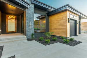 View of exterior entry featuring garage