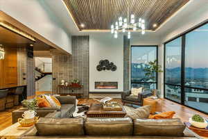 Hardwood floored living room with a wealth of natural light and a raised ceiling