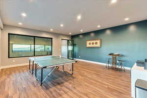 Recreation room featuring light hardwood floors