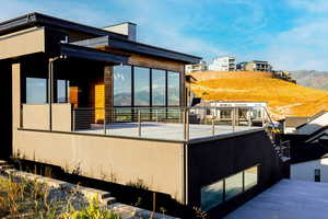 View of property exterior featuring a balcony and a mountain view