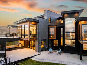 Back house at dusk with a patio