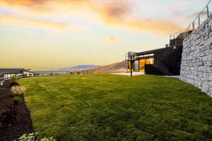 Yard at dusk featuring a patio and a mountain/lake views