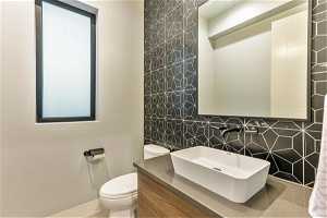 Bathroom with backsplash, mirror, tile walls, and large vanity