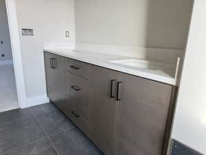 Bathroom with tile patterned flooring and vanity