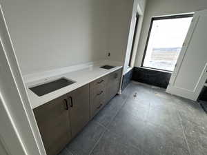 Bathroom with tile patterned flooring and sink