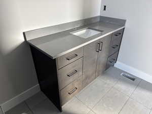 Kitchen with light tile patterned floors and sink