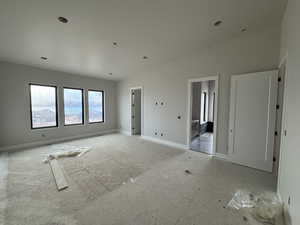 Spare room featuring lofted ceiling