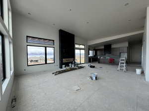 Unfurnished living room featuring vaulted ceiling