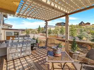 Deck with a pergola and area for grilling