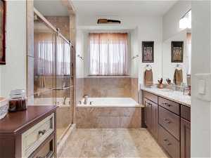 Bathroom with plus walk in shower, vanity, and tile floors