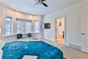 Main bedroom featuring ensuite bath and ceiling fan