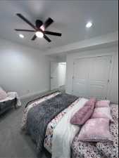 Bedroom featuring carpet floors, ceiling fan, and a closet