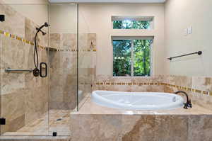 Bathroom featuring shower with separate bathtub