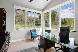 Office featuring lofted ceiling, plenty of natural light, ceiling fan, and light hardwood / wood-style flooring