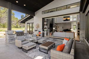 View of terrace featuring outdoor lounge area, an outdoor kitchen, and grilling area