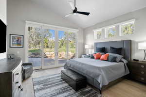 Bedroom featuring high vaulted ceiling, ceiling fan, light hardwood / wood-style flooring, and access to outside