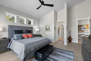 Bedroom with high vaulted ceiling, ceiling fan, and light wood-type flooring