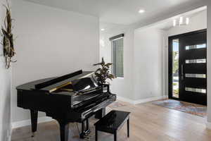 Foyer entrance with light hardwood / wood-style floors and a healthy amount of sunlight