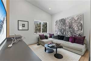 Living room featuring lofted ceiling and light hardwood / wood-style floors