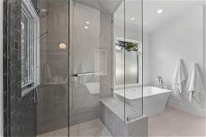 Bathroom with shower with separate bathtub and tile floors