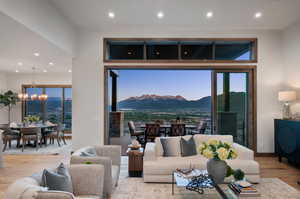 Living room with a chandelier, a mountain view, and light hardwood / wood-style flooring