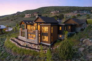 Back house at dusk with a balcony and a mountain view