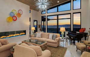 The living room offers a vaulted ceiling, floor -to-ceiling windows and a beautiful gas fireplace with LED lighting.