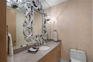 Powder bath with custom wall treatment and hand blown glass faucet with silver inlays.