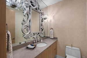 Powder bath with custom wall treatment and hand blown glass faucet with silver inlays.