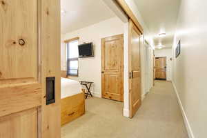 Corridor with light colored carpet