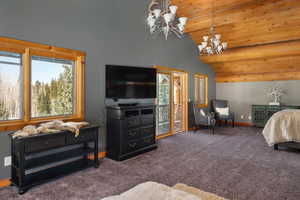 Carpeted bedroom featuring a chandelier, access to outside, baseboards, high vaulted ceiling, and wooden ceiling