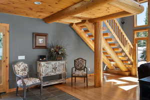 Sitting room with stairs, beam ceiling, wood ceiling, baseboards, and recessed lighting
