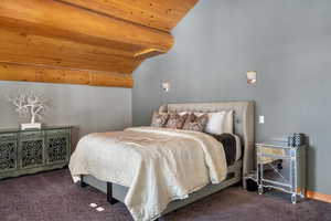 Carpeted bedroom with wooden ceiling