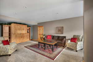 Living room featuring light colored carpet, recessed lighting, and baseboards