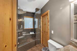 Full bath with toilet and a shower stall