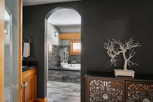 Full bathroom featuring vanity and a garden tub