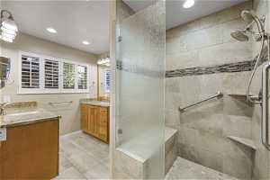 Bright New Custom Primary Bathroom suite with Double Marble Vanities, oversized shower w bench and grab bars.