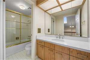 Upstairs Full bathroom with tile floors, toilet, vanity, and enclosed tub / shower