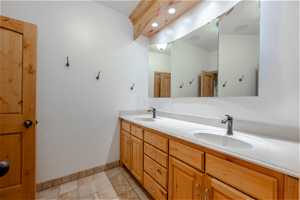 Bathroom with tile flooring and double vanity