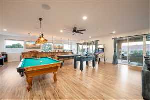 Rec room featuring ceiling fan, pool table, a wealth of natural light, and light hardwood flooring