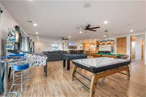 Recreation room featuring ceiling fan, pool table, and light hardwood flooring