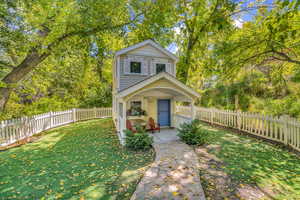 View of property with a front yard and an outbuilding