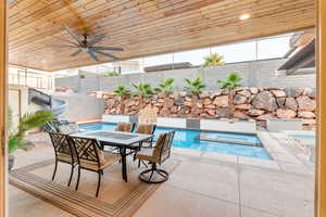 View of pool with an in ground hot tub, a patio area, and ceiling fan