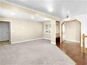 Empty room featuring carpet and ornamental molding