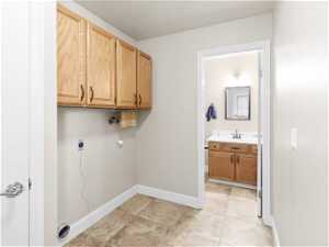laundry room. hookup for an electric dryer, and cabinets