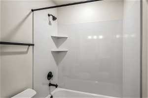 Bathroom with shower / bathtub combination and toilet