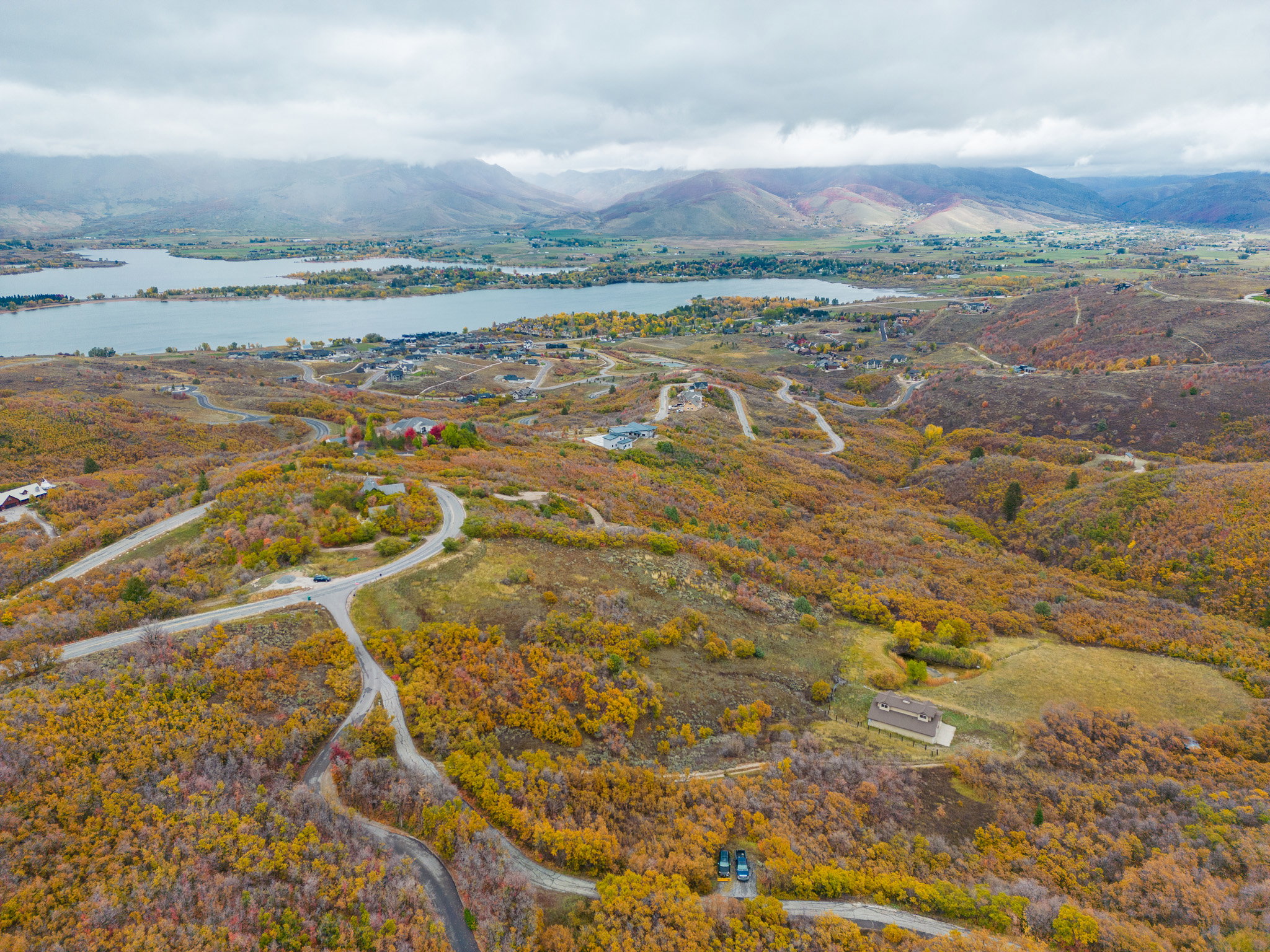 Drone / aerial view featuring a water and mountain view