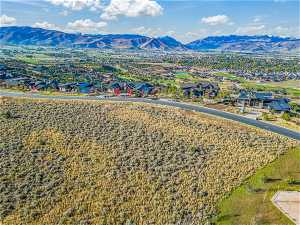 Birds eye view of property with a mountain view to the with holes 16 & 17