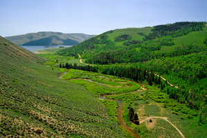 Property view of mountains featuring a water view